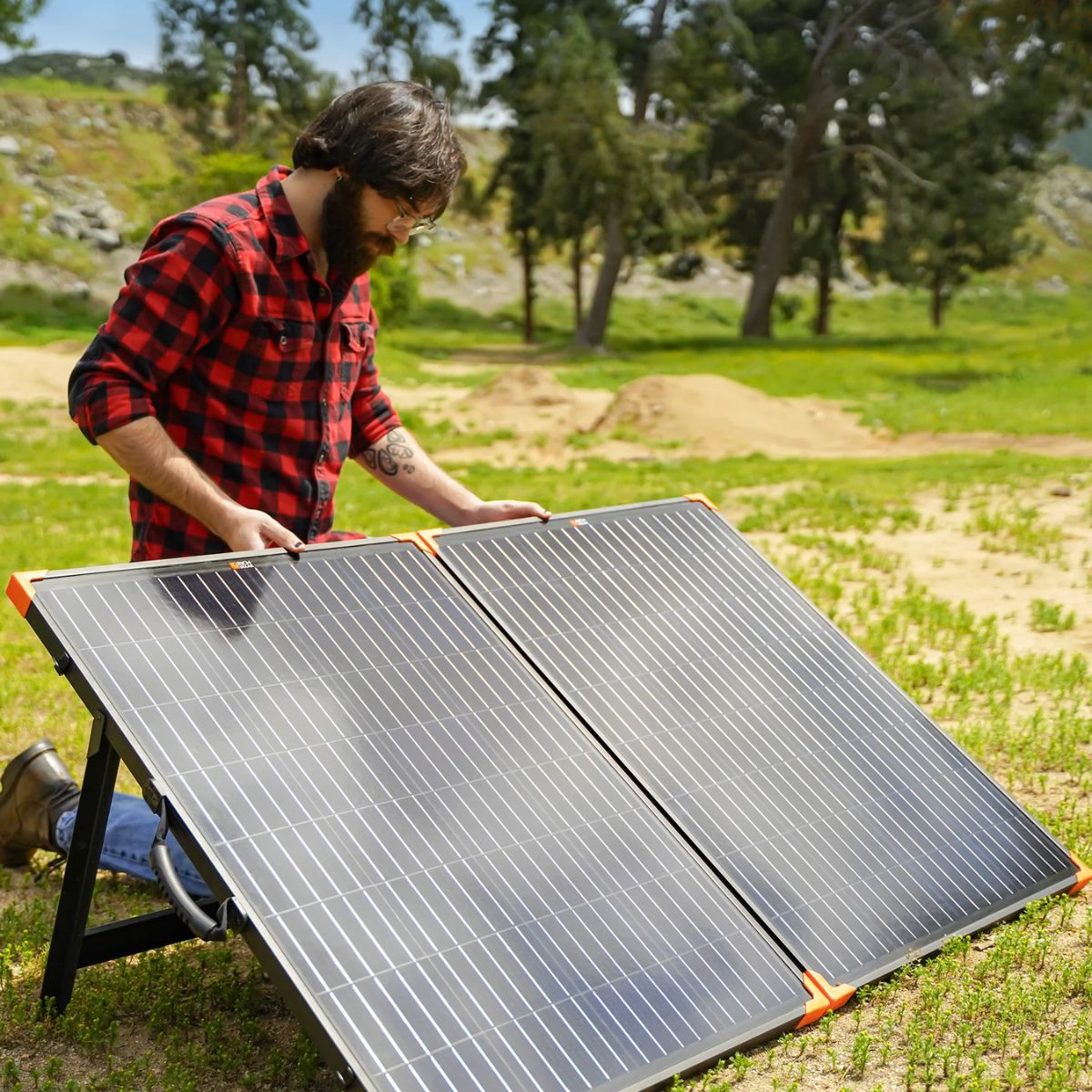 Setting up the Rich Solar RS-X200B MEGA 200W Portable Solar Panel Briefcase outside displaying how easy to set it up